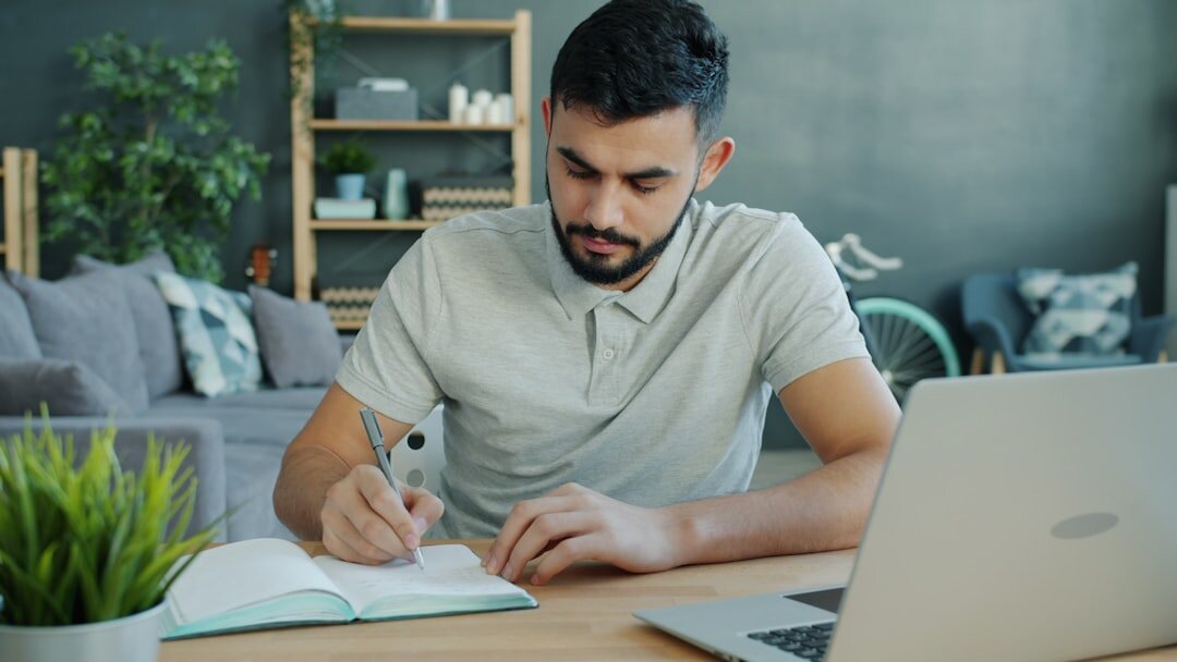 person writing in notebook